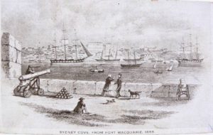 A sepia toned postcard featuring an image of Sydney Cove, titled " SYDNEY COVE, FROM FORT MACQUARIE, 1855". Courtesy of the National Museum of Australia.