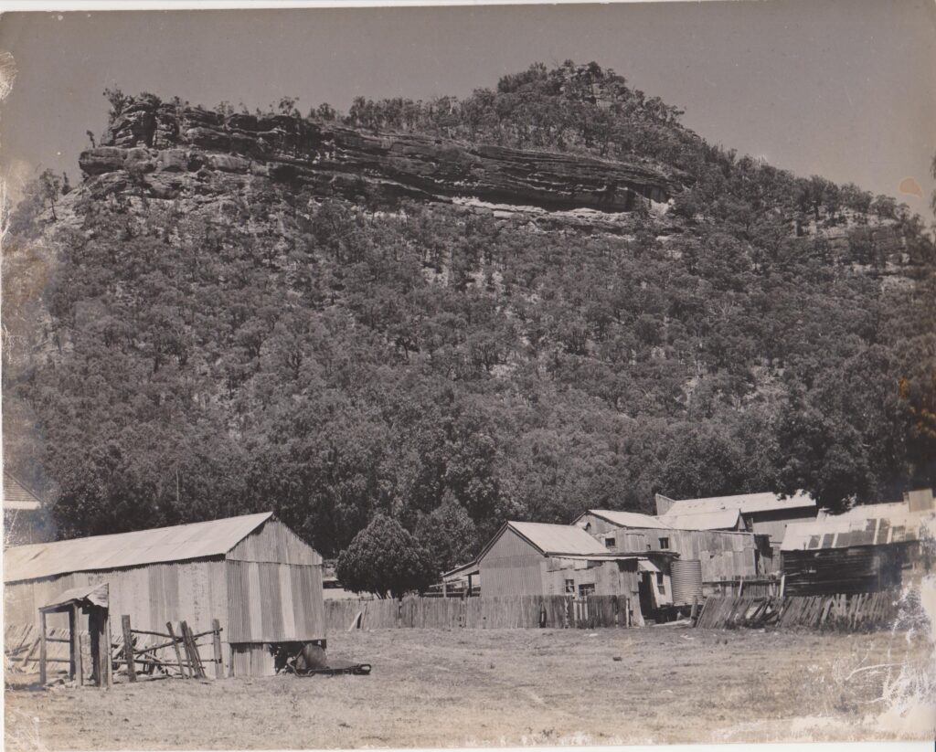 Yerranderie Township at the feet of Yerranderie Peak showing Bartlett Head at the left